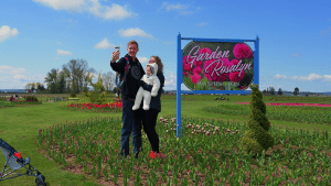 family taking a selfie in front of garden rosalyn sign